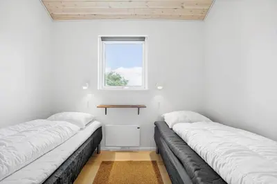 two beds in a room with a window at JB208-Brovst-Kronvildtvej-8 in Brovst