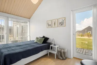 a bedroom with a bed and a large window at JB307-Brovst-Kronvildtvej-130 in Brovst
