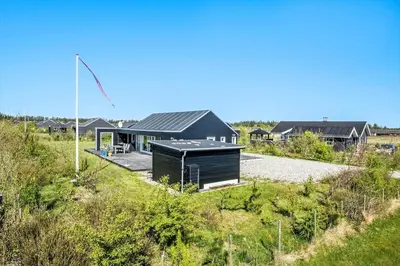 a black house in the middle of a field at JB307-Brovst-Kronvildtvej-130 in Brovst
