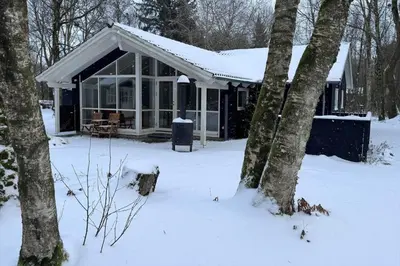 a house covered in snow in the woods at JB901-Aabybro-Graanden-40 in Åbybro