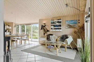 a living room with a couch and a table at JB827-Fjerritslev-Revlingestien-93 in Fjerritslev