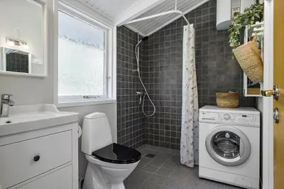 a bathroom with a toilet and a washing machine at JB922-Fjerritslev-Birkevej-25 in Fjerritslev