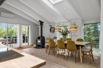 a dining room with a table and chairs and a fireplace at JB922-Fjerritslev-Birkevej-25 in Fjerritslev