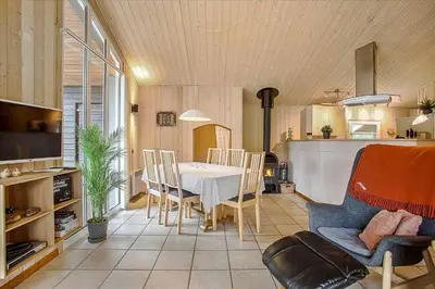 a kitchen and dining room with a table and chairs at JB699-Fjerritslev-Revlingestien-43 in Fjerritslev