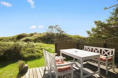 a table and chairs on a wooden deck with a table and chairs at JB155-Frostrup-Svenstibakkevej-5 in Frøstrup