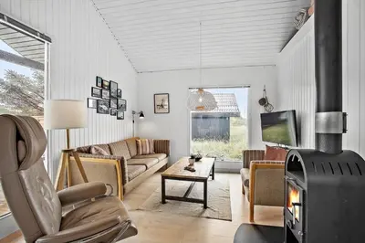 a living room with a couch and a fireplace at JB155-Frostrup-Svenstibakkevej-5 in Frøstrup