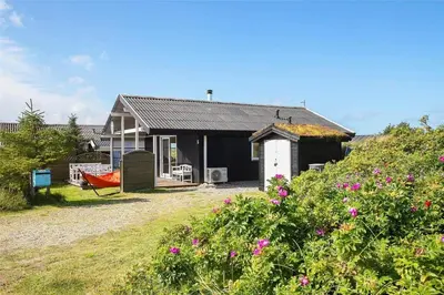 a small house with a red boat in front of it at JB155-Frostrup-Svenstibakkevej-5 in Frøstrup