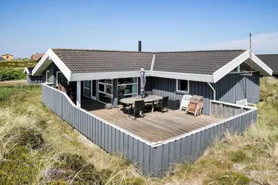 a house with a deck on the beach at JB340-Frostrup-Krinkelkrogen-14 in Frøstrup