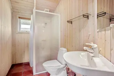 a bathroom with a toilet and a sink and a shower at JB340-Frostrup-Krinkelkrogen-14 in Frøstrup