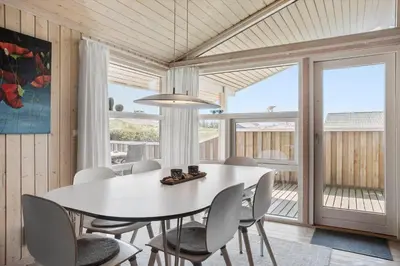 a dining room with a white table and chairs at JB340-Frostrup-Krinkelkrogen-14 in Frøstrup