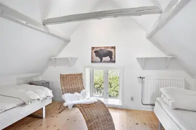 a room with two chairs and a bed and a window at JB151-Brovst-Tranum-Engevej-137 in Brovst