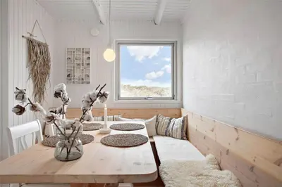 a dining room with a wooden table and a window at JB163-Brovst-Ejstrup-Strandvej-32 in Brovst