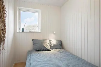 a bedroom with a bed and a window at JB163-Brovst-Ejstrup-Strandvej-32 in Brovst