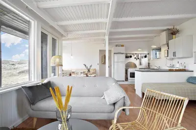 a living room with a couch and a kitchen at JB163-Brovst-Ejstrup-Strandvej-32 in Brovst