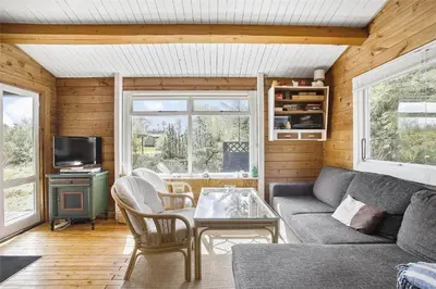 a living room with a couch and a table at JB988-Fjerritslev-Skovstien-6 in Fjerritslev