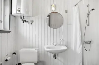 a bathroom with a sink and a toilet and a mirror at JB785-Fjerritslev-Tolderstien-24 in Fjerritslev