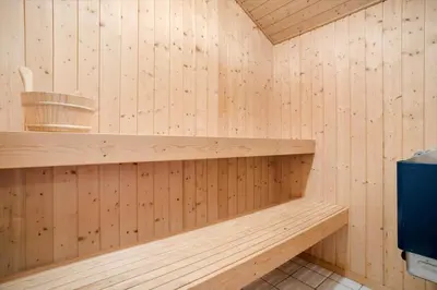 a wooden sauna with a wooden shelf and a bucket at JB818-Fjerritslev-Ronnevej-20 in Fjerritslev