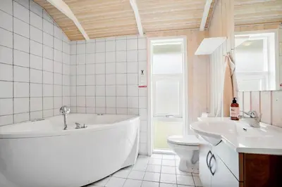 a bathroom with a tub and a toilet and a sink at JB818-Fjerritslev-Ronnevej-20 in Fjerritslev