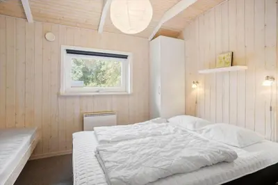 a bedroom with a white bed and a window at JB818-Fjerritslev-Ronnevej-20 in Fjerritslev