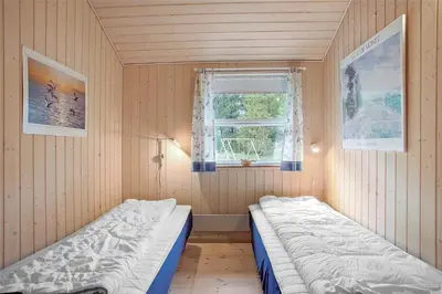 a small room with two beds and a window at JB136-Brovst-Harestien-1 in Brovst