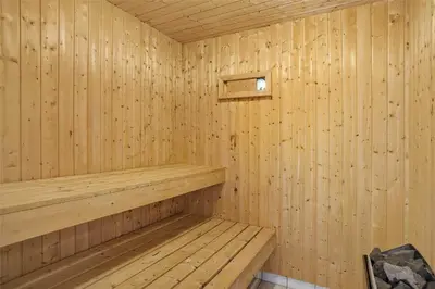 a wooden sauna with a wooden bench in it at JB538-Fjerritslev-Tyttebaerstien-33 in Fjerritslev