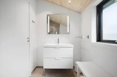 a white bathroom with a sink and a mirror at JB229-Fjerritslev-Hasselvej-13 in Fjerritslev