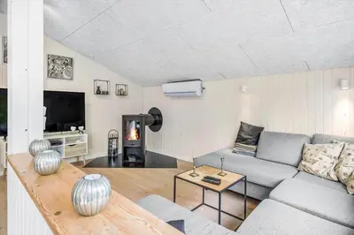 a living room with a couch and a tv at JB118-Fjerritslev-Ahornvej-8 in Fjerritslev
