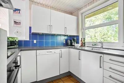 a white kitchen with a sink and a window at JB305-Fjerritslev-Tyttebaerstien-18 in Fjerritslev