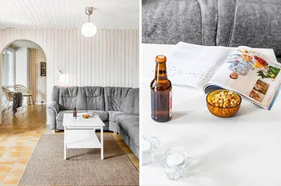 a living room with a bed and a bottle of wine at JB305-Fjerritslev-Tyttebaerstien-18 in Fjerritslev