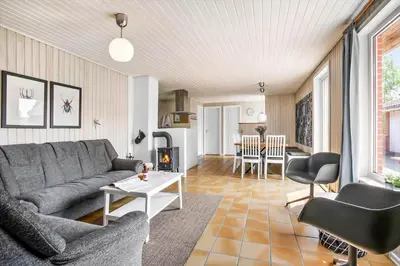 a living room with a couch and a table at JB305-Fjerritslev-Tyttebaerstien-18 in Fjerritslev
