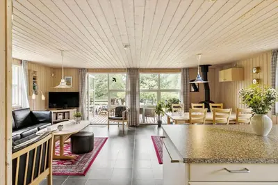 a kitchen and living room with a couch and a table at JB139-Fjerritslev-Kastanievej-13 in Fjerritslev