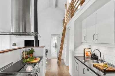 a kitchen with white cabinets and a sink at JB215-Brovst-Kronvildtvej-194 in Brovst