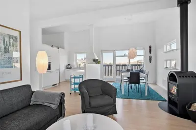 a living room with a couch and a dining room at JB140-Frostrup-Svenstibakkevej-68 in Frøstrup