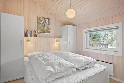a bedroom with a white bed with a window at JB185-Fjerritslev-Poppelvej-26 in Fjerritslev