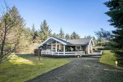 a large house with a porch and a driveway at JB185-Fjerritslev-Poppelvej-26 in Fjerritslev