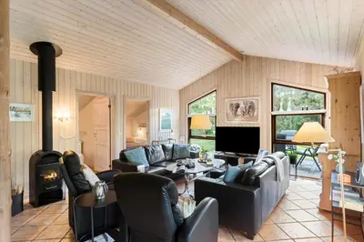 a living room with leather furniture and a fireplace at JB245-Fjerritslev-Tyttebaerstien-44 in Fjerritslev