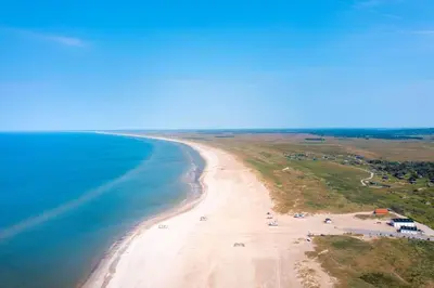 an aerial view of a sandy beach next to the ocean at JB294-Fjerritslev-Perikumvej-72 in Fjerritslev