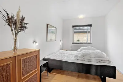 a bedroom with a bed and a dresser at JB148-Fjerritslev-Svinklovvej-107 in Fjerritslev