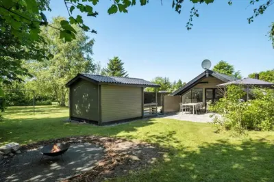 a house with a fire pit in the yard at JB273-Fjerritslev-Hasselvej-39 in Fjerritslev