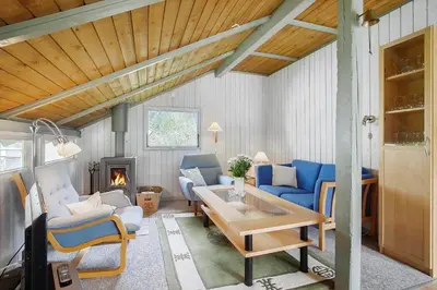 a living room with blue chairs and a table at JB329-Brovst-Egernvej-29 in Brovst