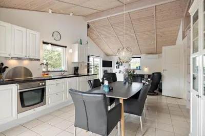 a kitchen and dining room with a table and chairs at JB234-Frostrup-Strandvejen-83-A in Frøstrup