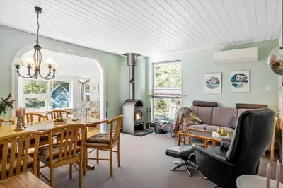 a living room with a couch and a dining room at JB246-Brovst-Graevlingevej-13 in Brovst