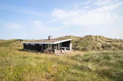 a small house sitting on top of a hill at JB119-Brovst-Ejstrup-Strandvej-18 in Brovst