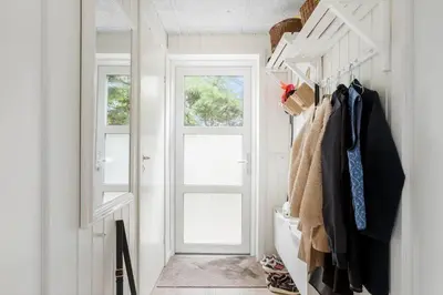 a room with a hallway with a door and coats at JB318-Fjerritslev-Fiskerstien-10 in Fjerritslev
