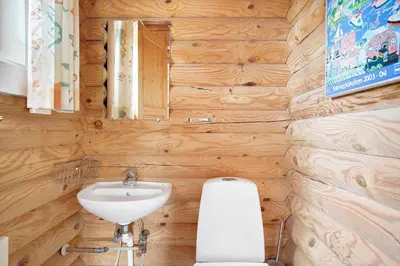 a bathroom with a sink and a toilet and a mirror at JB125-Fjerritslev-Lyngbjergvej-31 in Fjerritslev