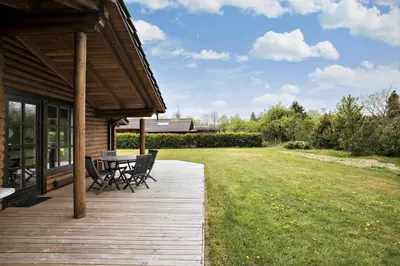 a wooden deck with a table and chairs on a house at JB125-Fjerritslev-Lyngbjergvej-31 in Fjerritslev