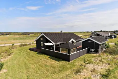 an aerial view of a black house in a field at JB187-Brovst-Kronvildtvej-128 in Brovst