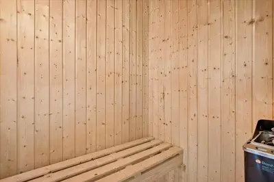 a room with a wooden wall with a bench at JB171-Brovst-Ejstrup-Strandvej-28 in Brovst