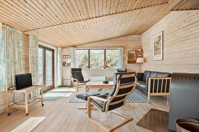 a living room with a couch and a tv at JB171-Brovst-Ejstrup-Strandvej-28 in Brovst