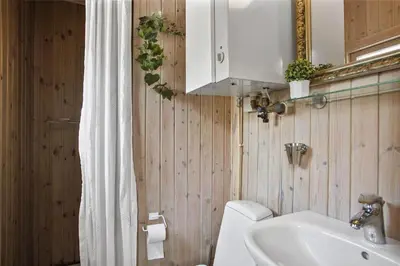 a bathroom with a sink and a toilet and a mirror at JB102-Fjerritslev-Blabaerstien-7 in Fjerritslev